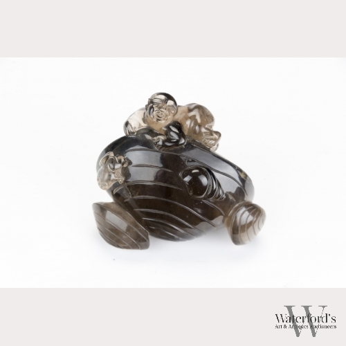 A Smoky Quartz Crystal Carving of Shells and a Boy