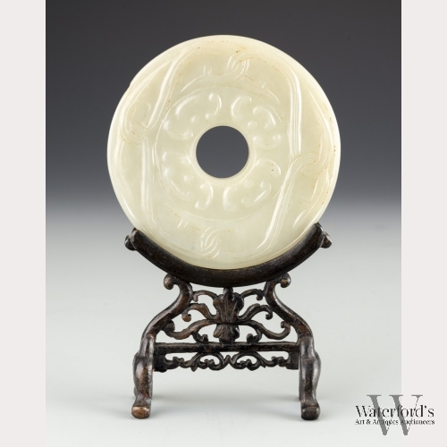 A Chinese White Jade Bi Disk in Wood Stand