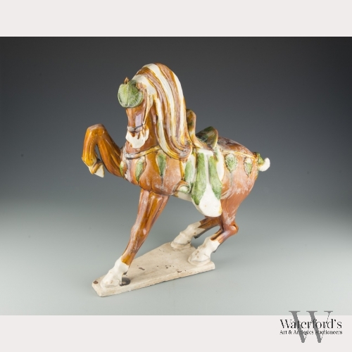 A Chinese Stoneware Sancai Model of a Horse