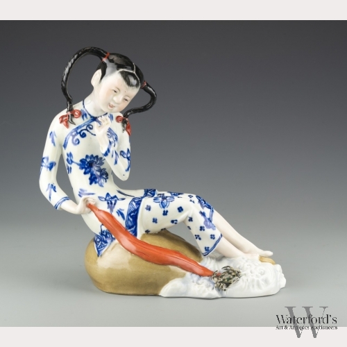 A Chinese Porcelain Figure of a Seated Girl