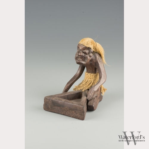 An Indonesian Wooden Figure of a Man Kneeling