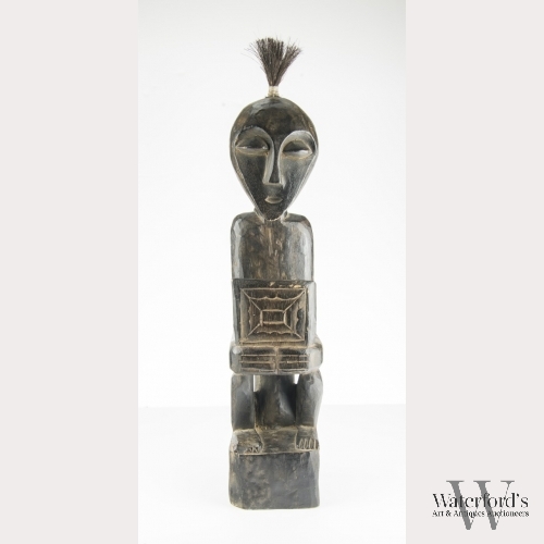 An African Carved Wood Seated Figure