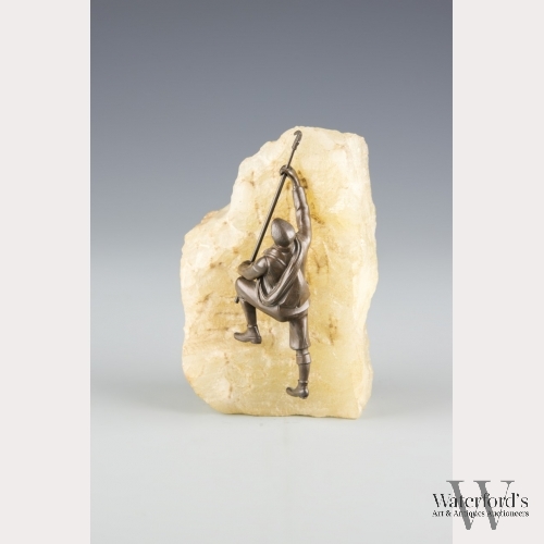 A Painted Metal Mountain Climber on a Rock Crystal